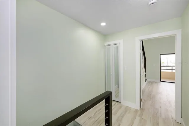 a view of hallway with wooden floor