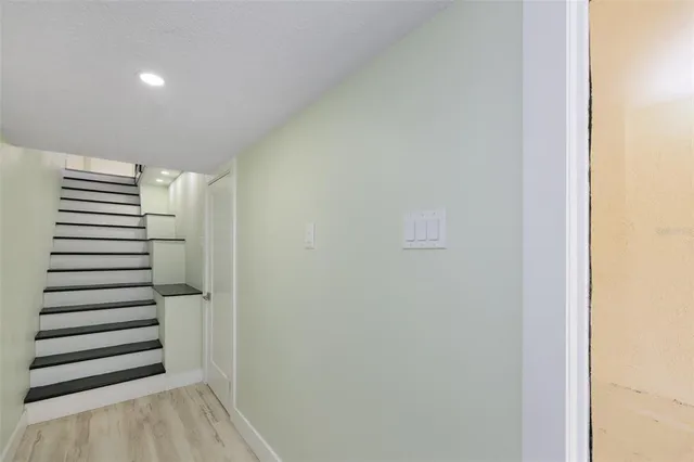 a view of entryway with stairs and wooden floor