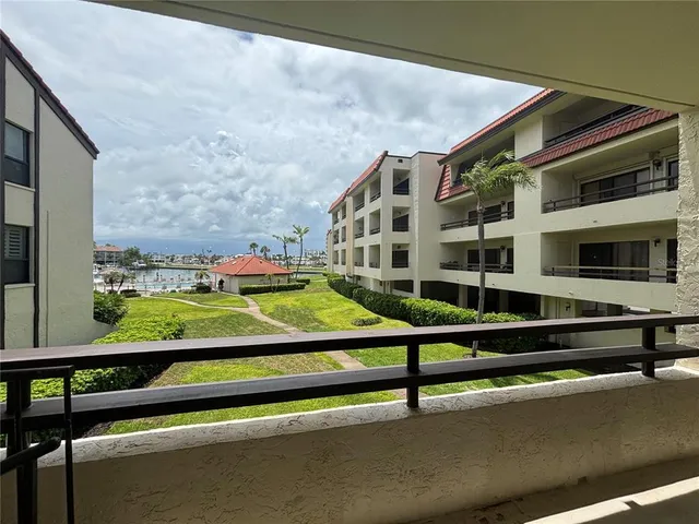 a wooden bench sitting in front of a building