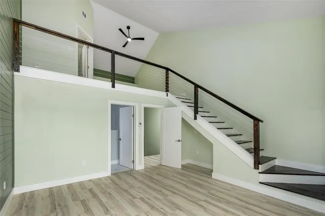 a view of entryway and hall with wooden floor