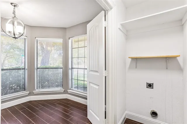 a view of a room with wooden floor and windows