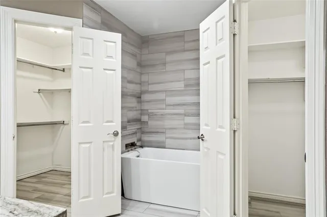 a bathroom with a bathtub and shower