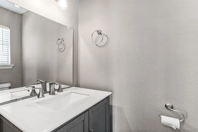a bathroom with a sink vanity and a mirror