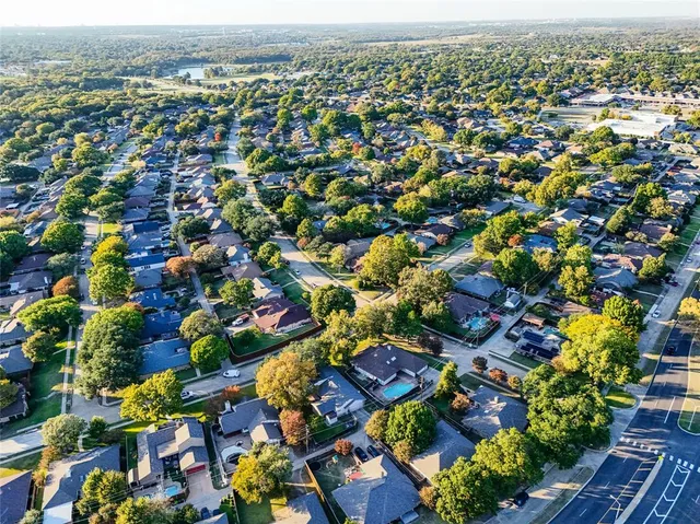 an aerial view of residential houses with outdoor space