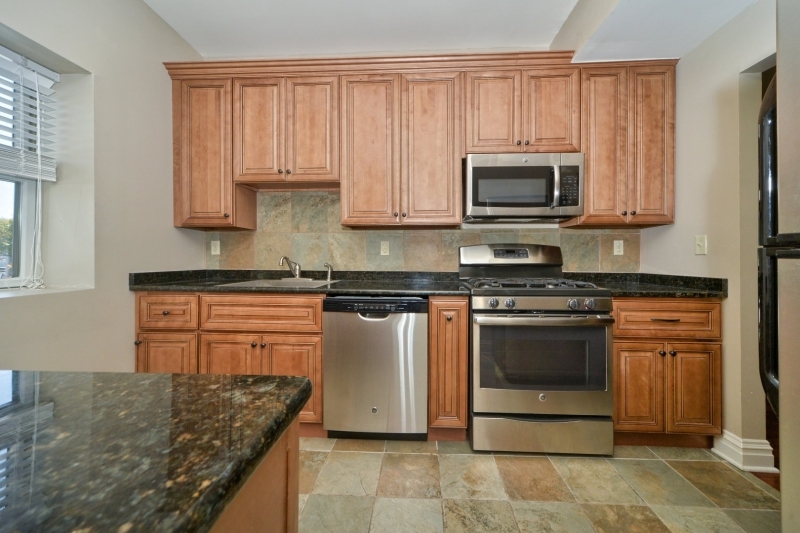 28 West Main Street, Unit 2D Somerville, NJ 08876 - Photo 2 of 13 a kitchen with stainless steel appliances granite countertop a stove a sink and a microwave