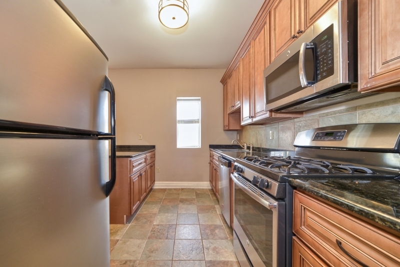 28 West Main Street, Unit 2D Somerville, NJ 08876 - Photo 3 of 13 a kitchen with stainless steel appliances granite countertop a stove and a refrigerator