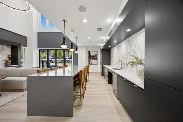 a view of a living room and kitchen with stainless steel appliances granite countertop lots of counter top space