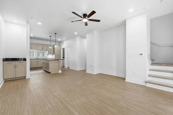 a view of an empty room with a kitchen