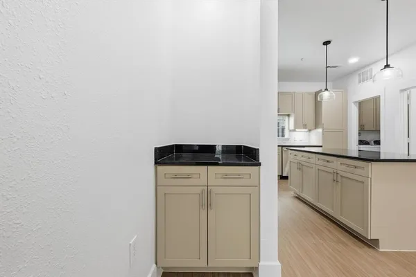 a kitchen with a refrigerator and a sink