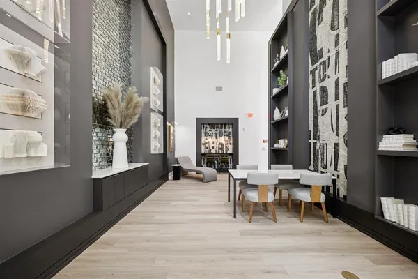a living room with furniture a large window and wood floor