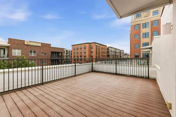 a view of a balcony with wooden floor