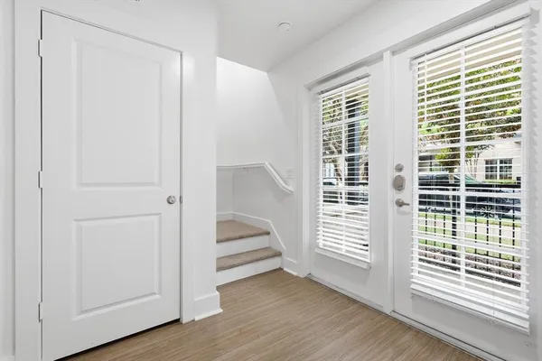 a view of entryway with wooden floor and windows