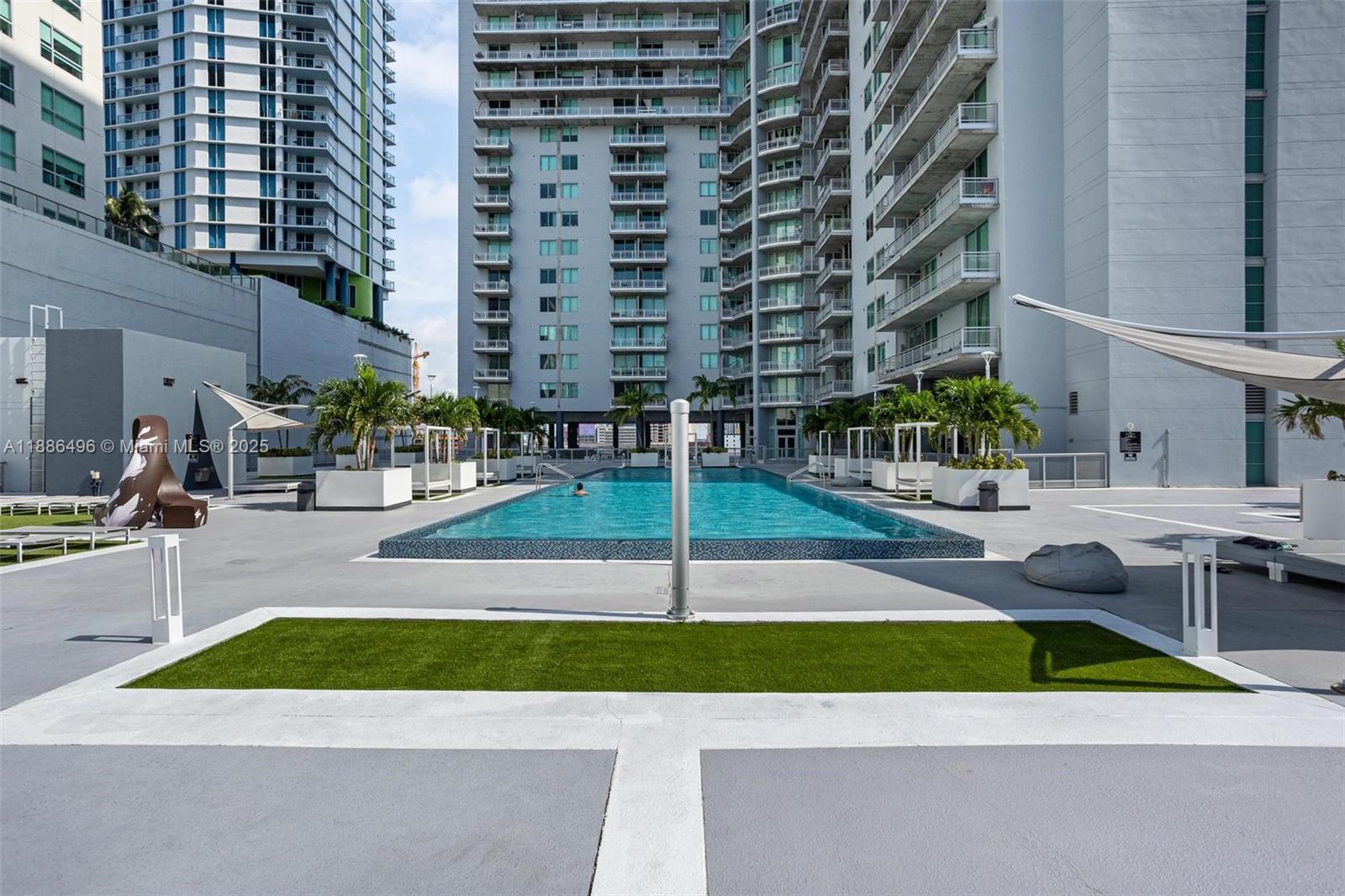 690 Southwest 1st Court, Unit 1213 Miami, FL 33130 - Photo 27 of 31 a view of a swimming pool with a lounge chairs