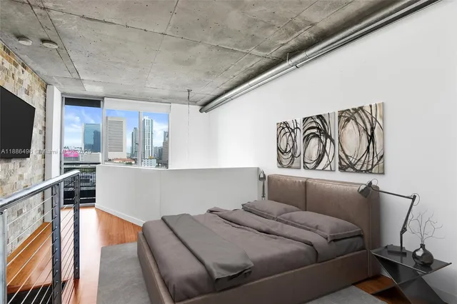 a bedroom with furniture and a flat screen tv