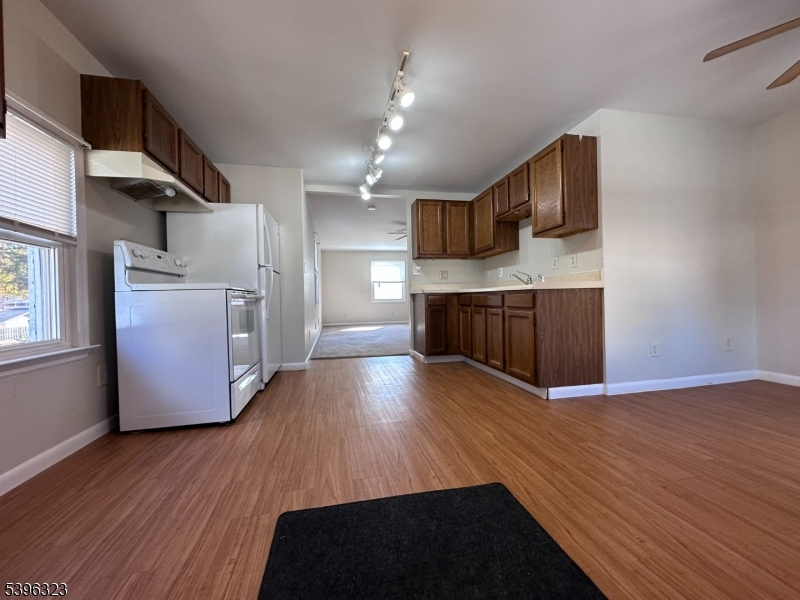 376 South Main Street, Unit 1 Wharton, NJ 07885 - Photo 8 of 14 a kitchen with stainless steel appliances wooden floors and refrigerator