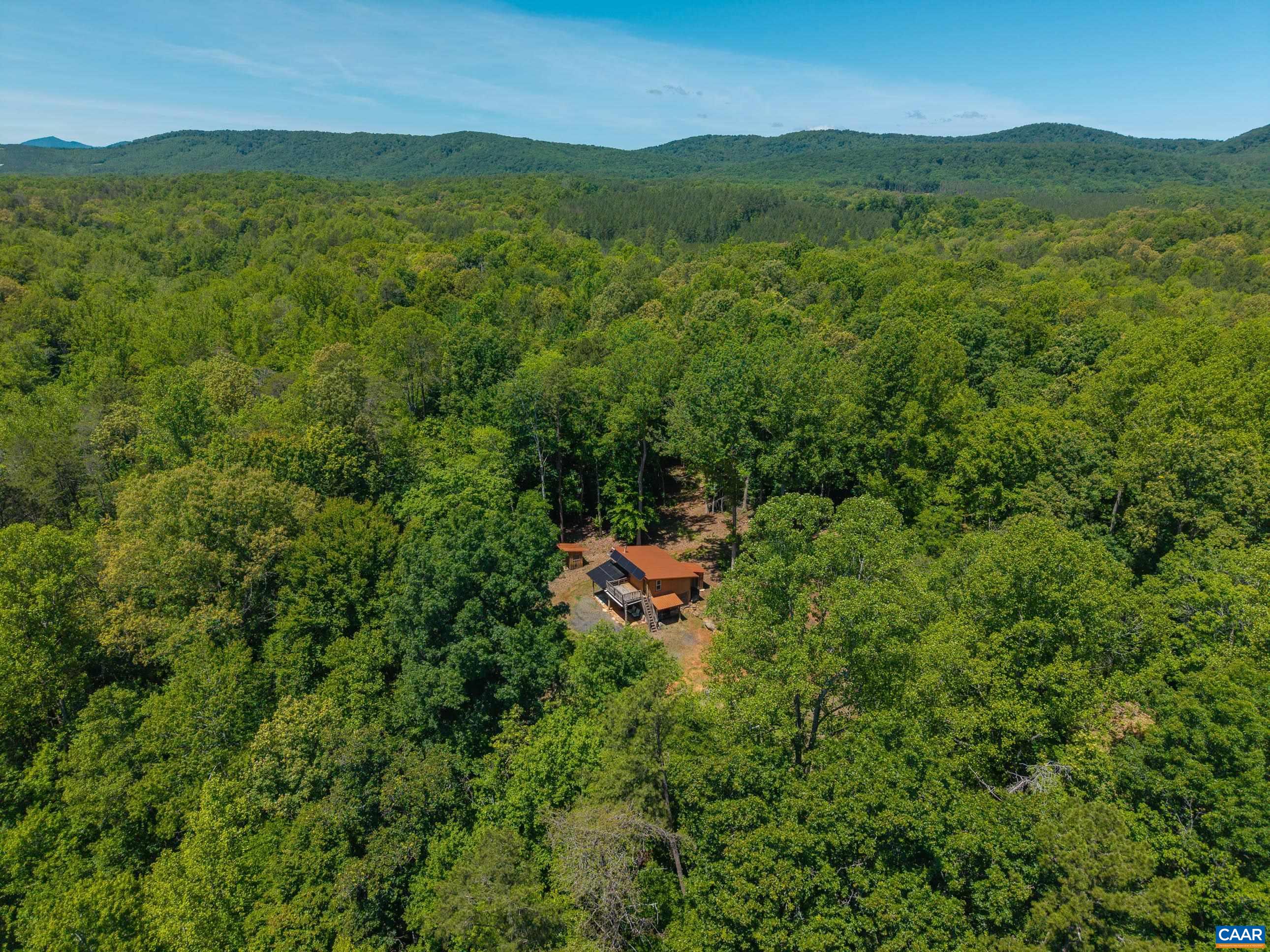 7676 Old Dominion Road Schuyler, VA 22969 - Photo 29 of 29 a view of a lush green hillside and a houses