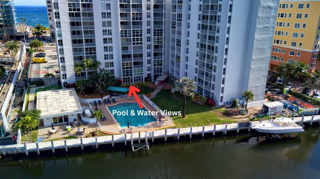 a view of swimming pool with outdoor seating and lake view