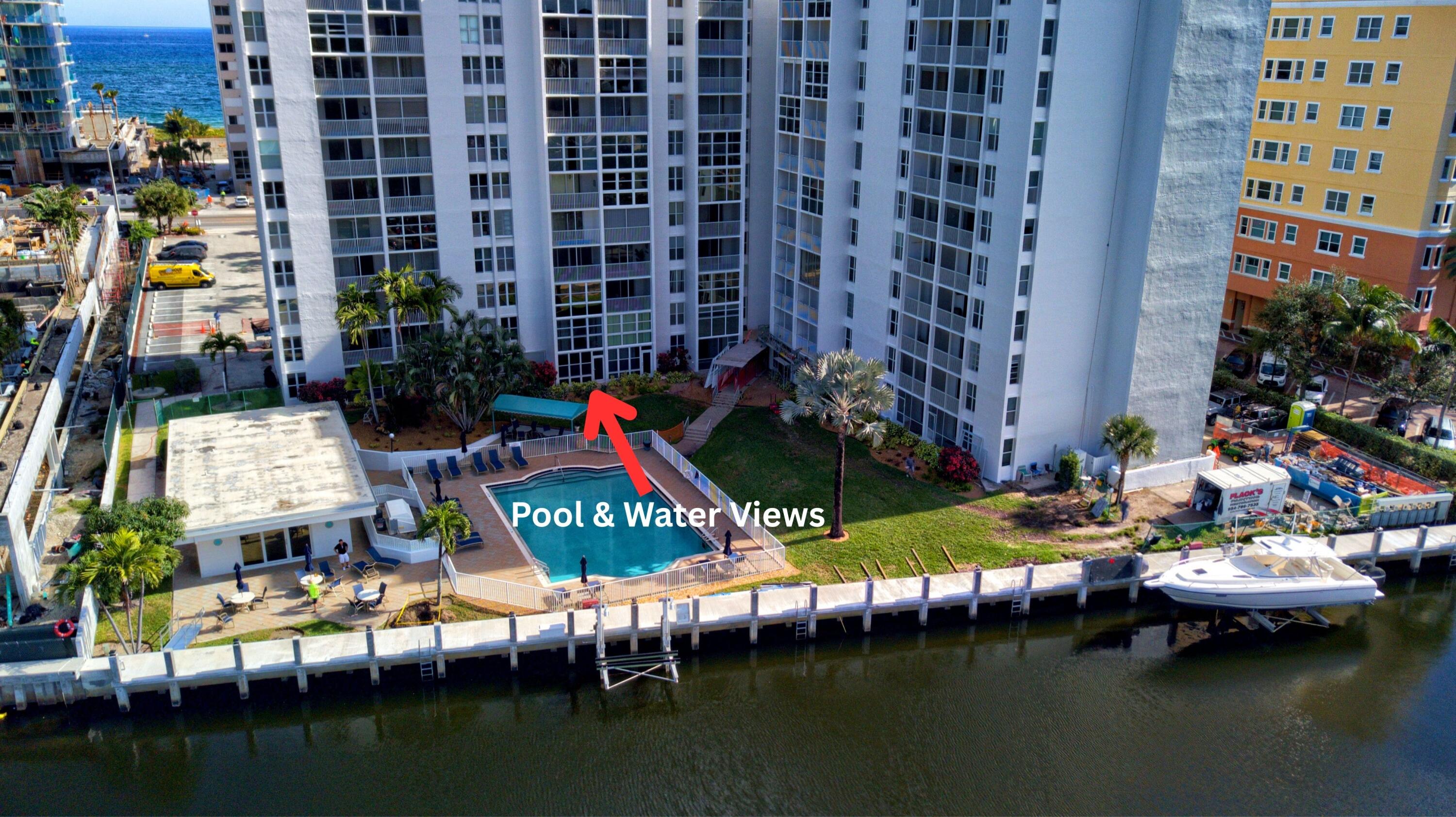 a view of swimming pool with outdoor seating and lake view