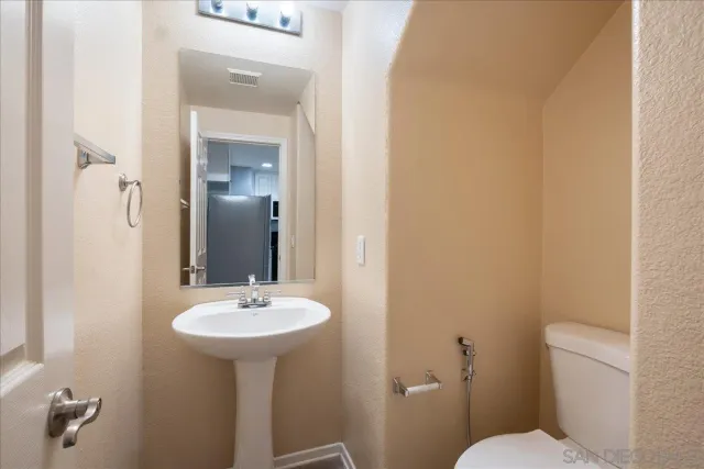 a bathroom with a sink toilet and mirror