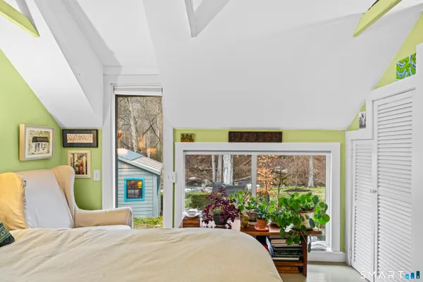 a bedroom with a bed and a painting on the wall