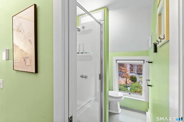 a bathroom with a sink toilet and a mirror