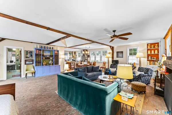 a living room with furniture a fireplace and a floor to ceiling window