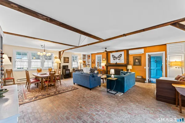 a living room with furniture a rug and a large window
