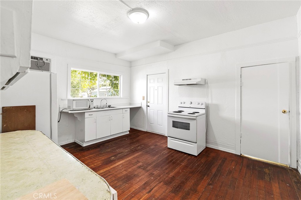 818 6th Street Corning, CA 96021 - Photo 8 of 32 a kitchen with a stove a sink and a refrigerator