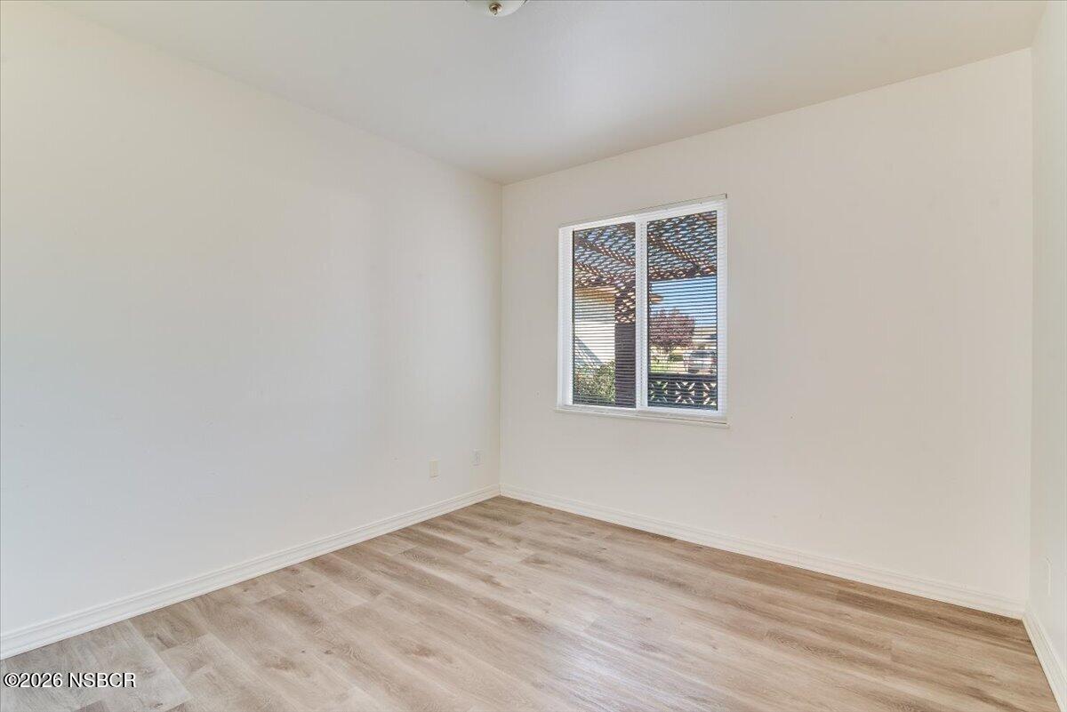 321 North Z Street Lompoc, CA 93436 - Photo 14 of 33 a view of an empty room with wooden floor and a window