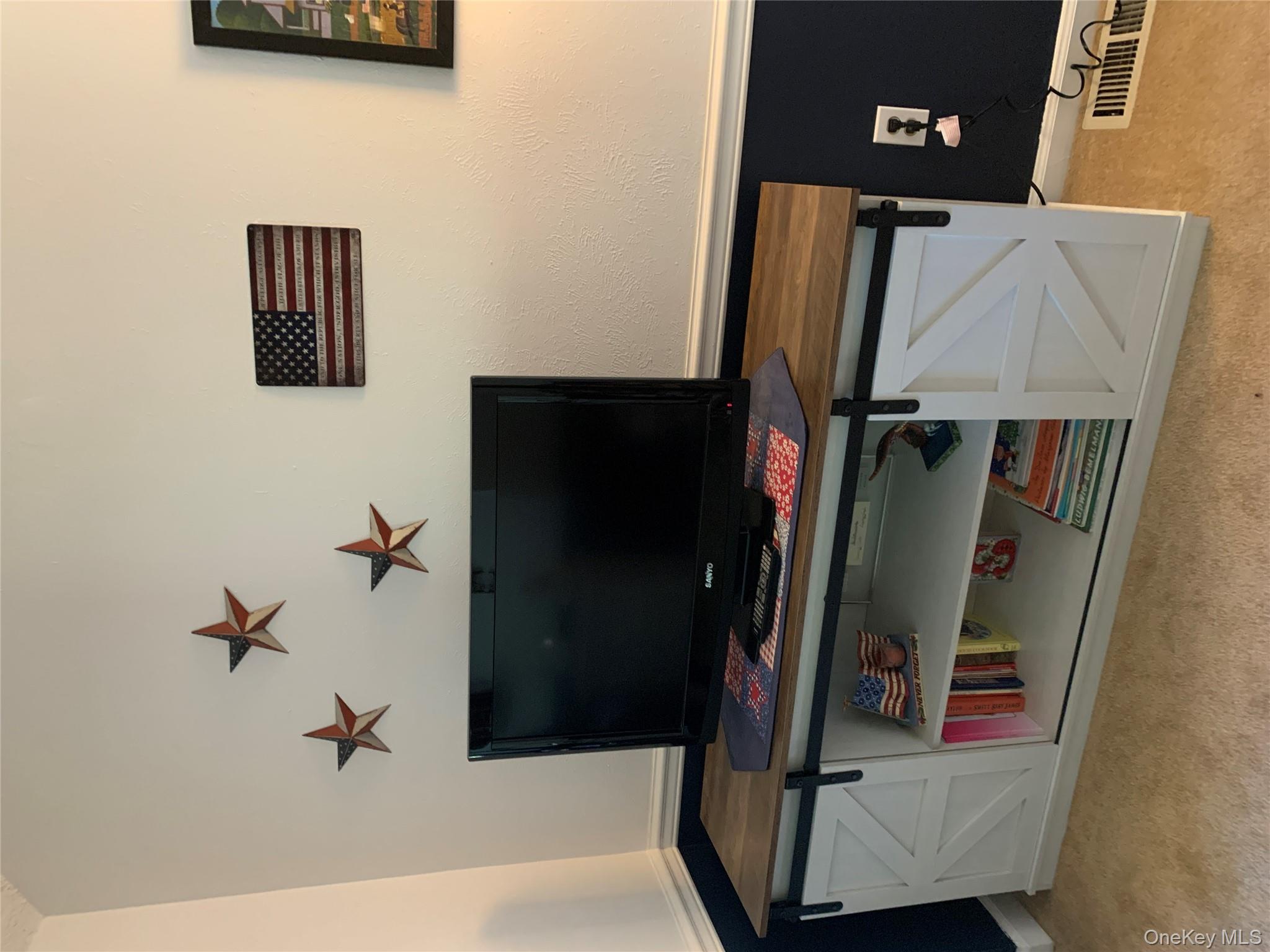 1 South Cambridge Court Fishkill, NY 12524 - Photo 23 of 49 a living room with furniture and a flat screen tv
