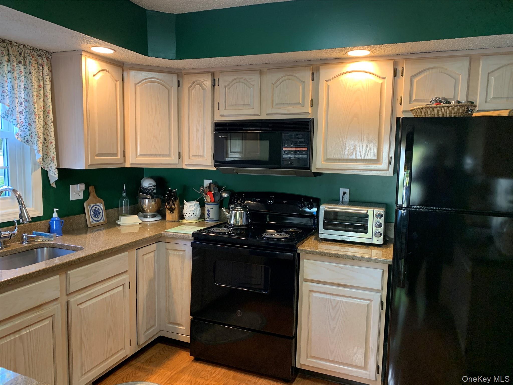 1 South Cambridge Court Fishkill, NY 12524 - Photo 7 of 49 a kitchen with a sink and a refrigerator