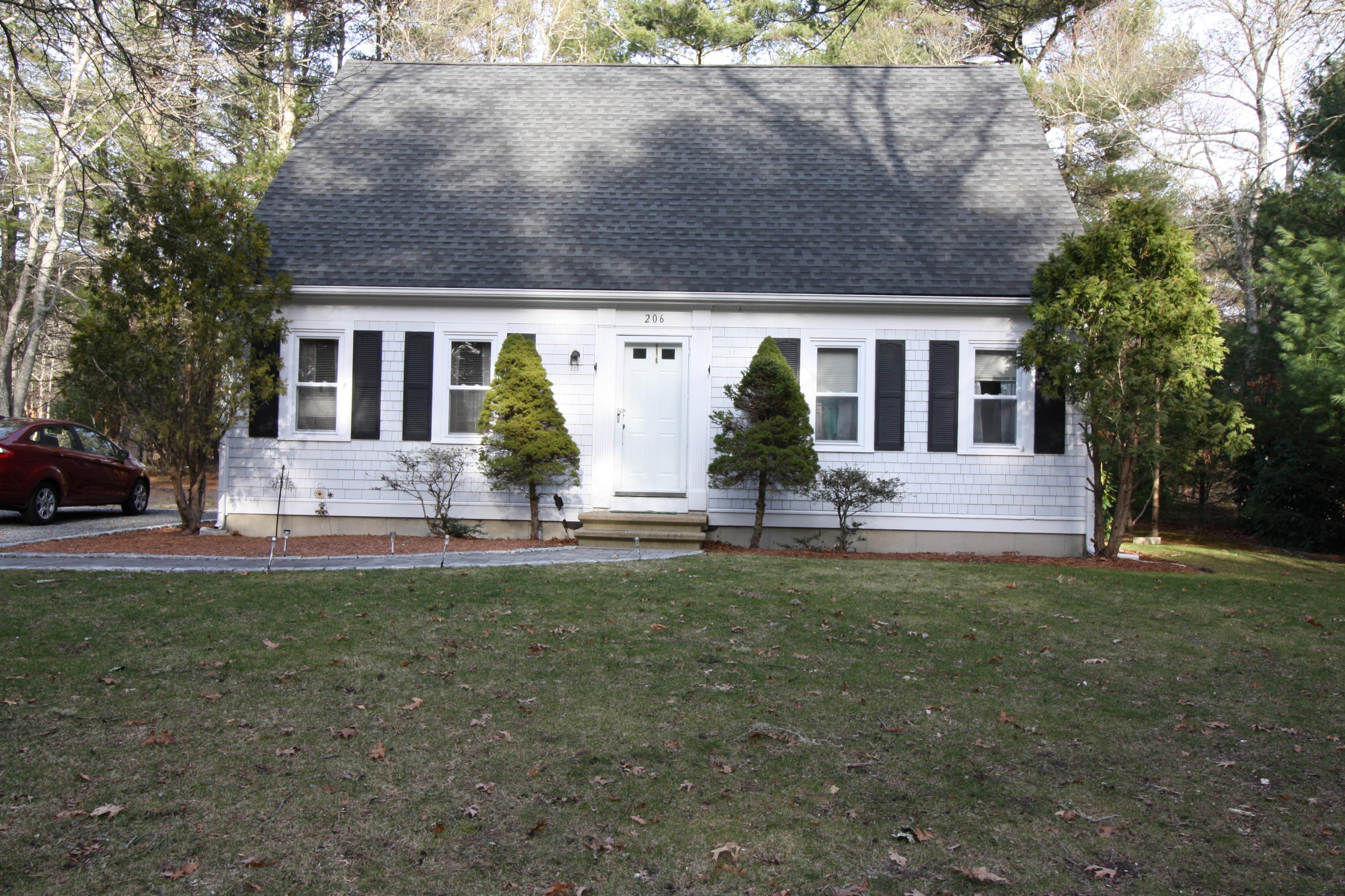 206 Nye Road Centerville, MA 02632 - Photo 1 of 14 a front view of house with yard and green space
