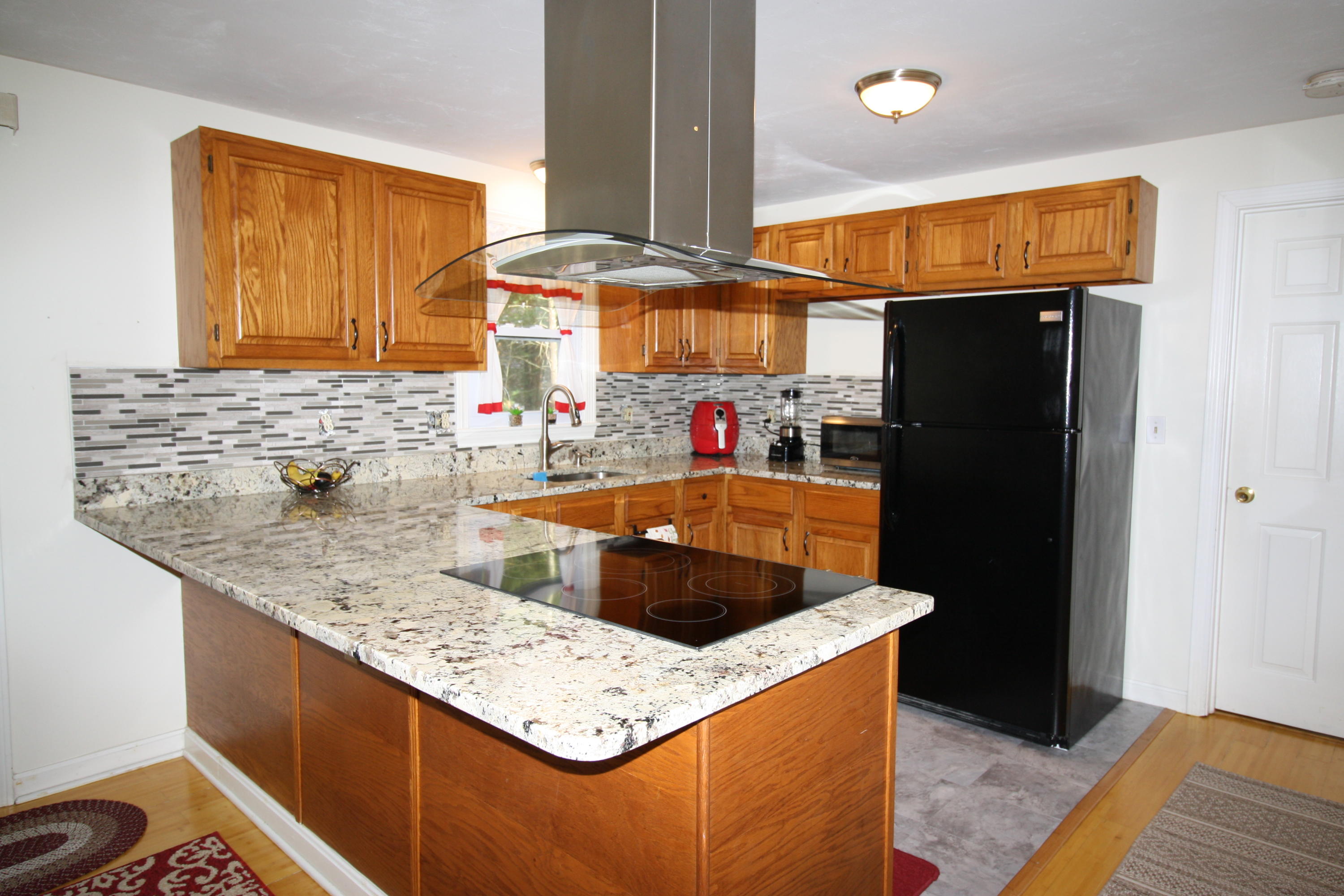 206 Nye Road Centerville, MA 02632 - Photo 2 of 14 a kitchen with stainless steel appliances granite countertop a sink and a refrigerator