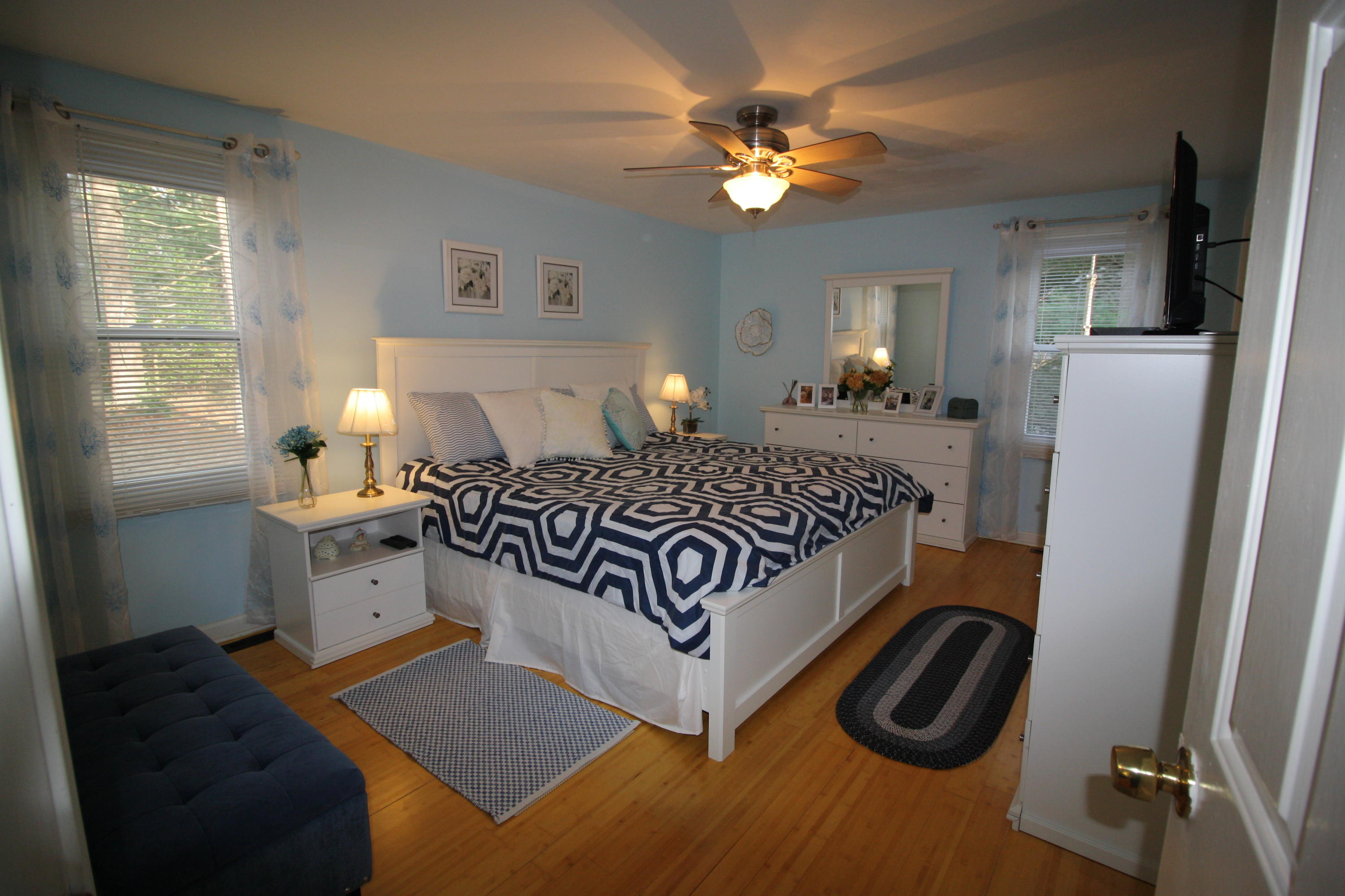206 Nye Road Centerville, MA 02632 - Photo 6 of 14 a bedroom with a bed and a chandelier