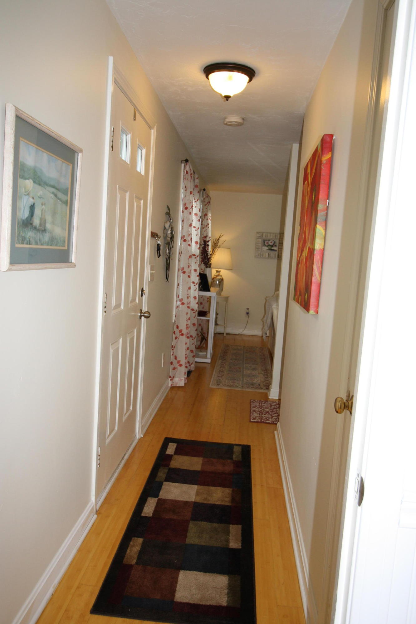 206 Nye Road Centerville, MA 02632 - Photo 9 of 14 a hallway with painting on the wall and a window
