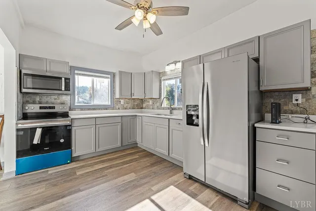 a kitchen with a sink cabinets and wooden floor