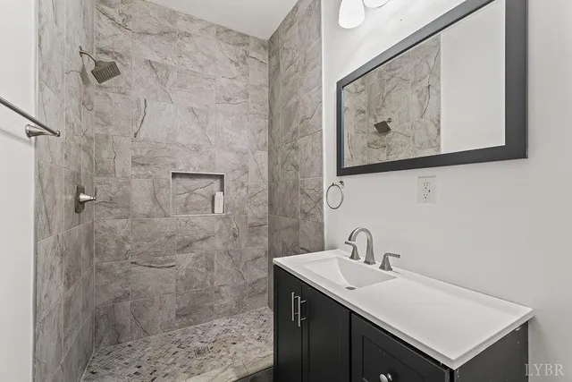 a bath room with a toilet a bath tub and a shower