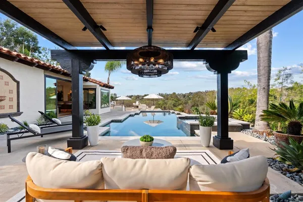 a view of a patio with couches chairs and a potted plant