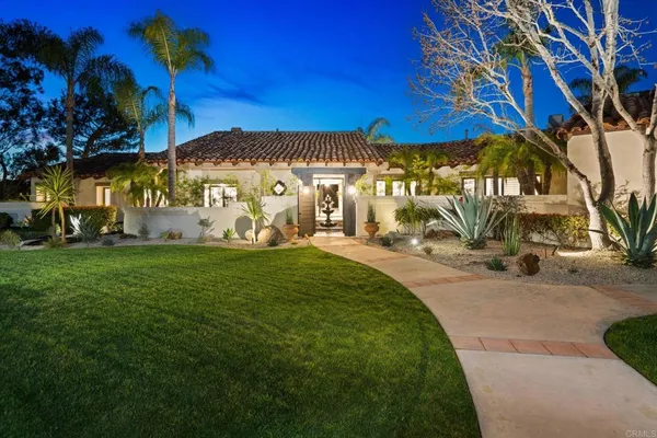 a backyard of a house with table and chairs