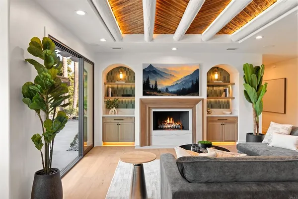 a dining room with furniture a chandelier and wooden floor