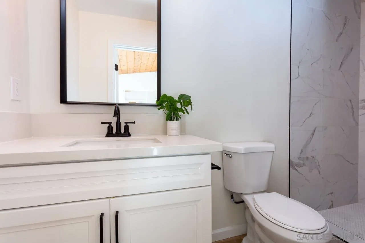 2610 Glebe Road Lemon Grove, CA 91945 - Photo 12 of 31 a bathroom with a toilet sink and mirror