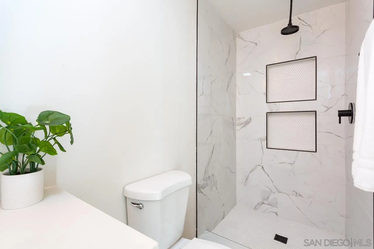 2610 Glebe Road Lemon Grove, CA 91945 - Photo 13 of 31 a white toilet sitting next to a bath tub