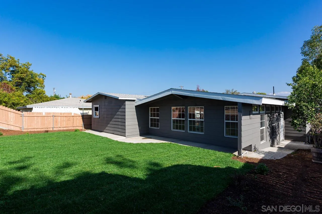 2610 Glebe Road Lemon Grove, CA 91945 - Photo 24 of 31 a view of a house with a yard and a large tree