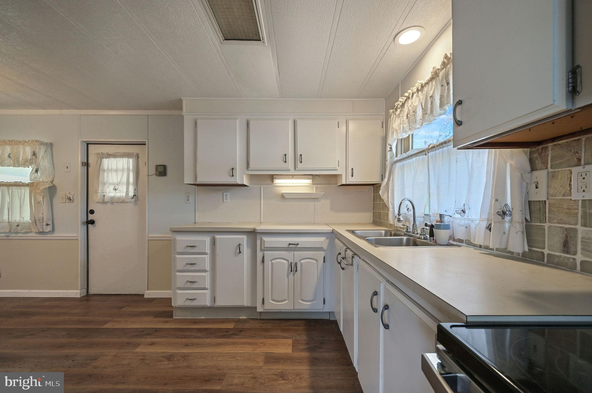3 Patterson Drive Georgetown, DE 19947 - Photo 11 of 25 a kitchen with a sink cabinets and window