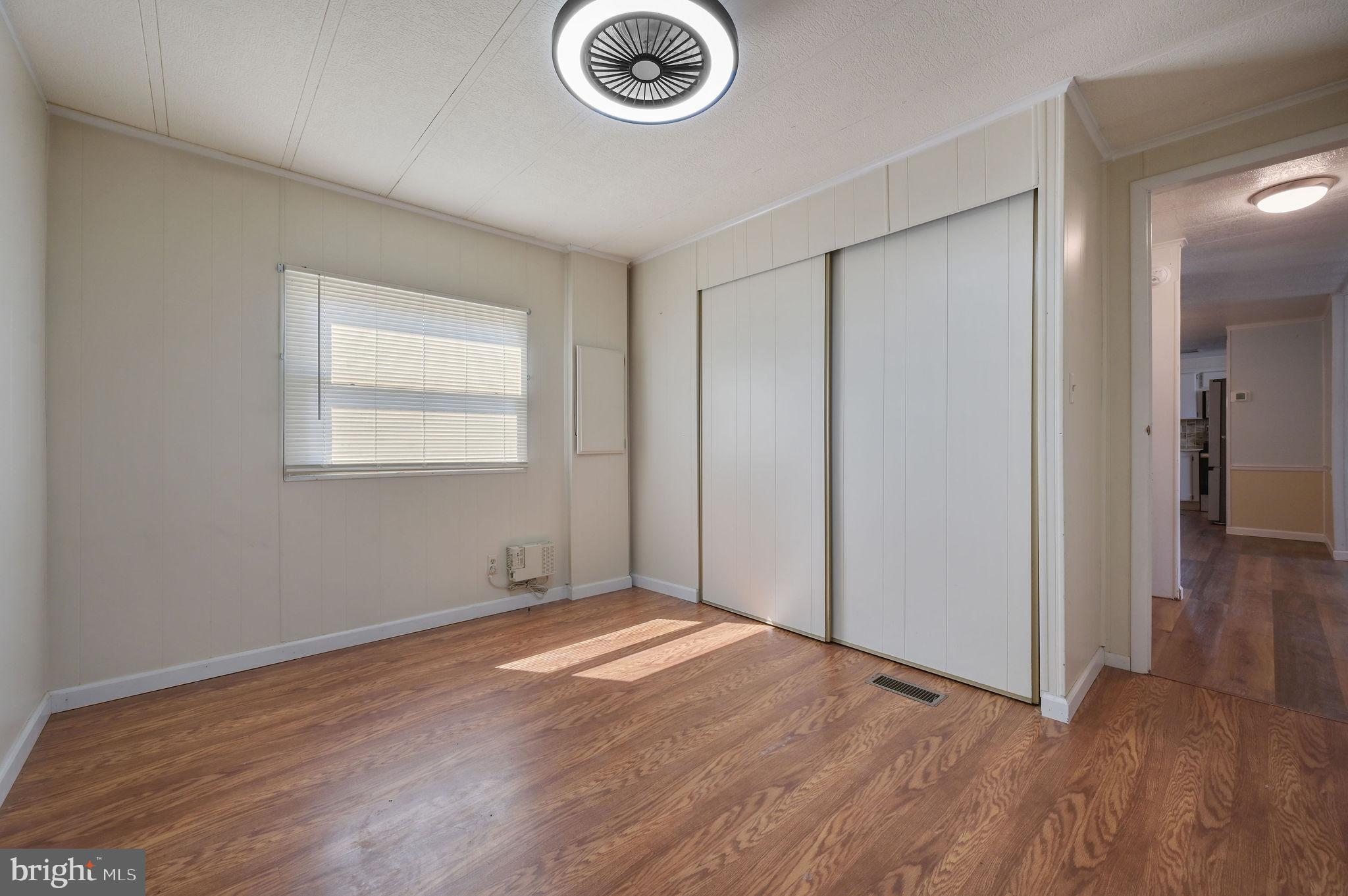 3 Patterson Drive Georgetown, DE 19947 - Photo 24 of 25 an empty room with wooden floor and windows
