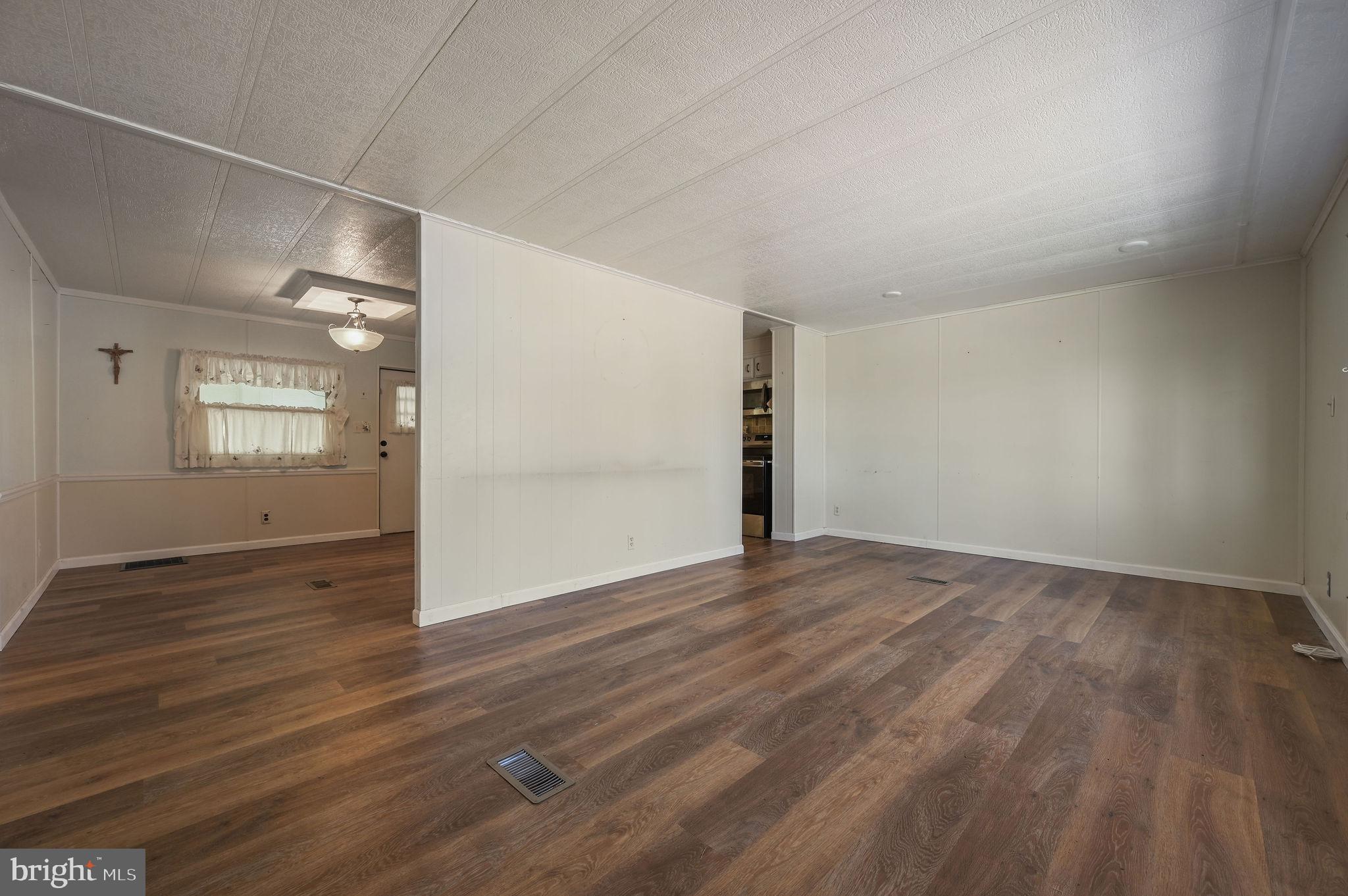 3 Patterson Drive Georgetown, DE 19947 - Photo 6 of 25 an empty room with wooden floor and windows