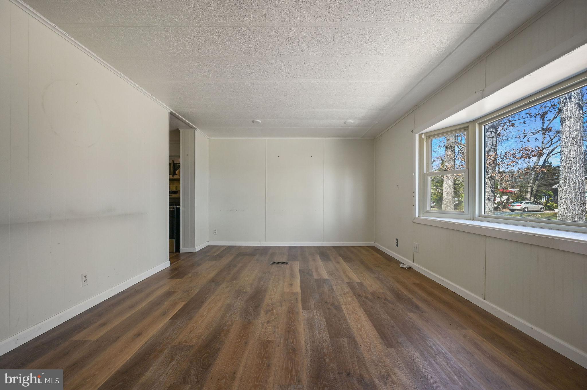 3 Patterson Drive Georgetown, DE 19947 - Photo 7 of 25 a view of an empty room with wooden floor and a window