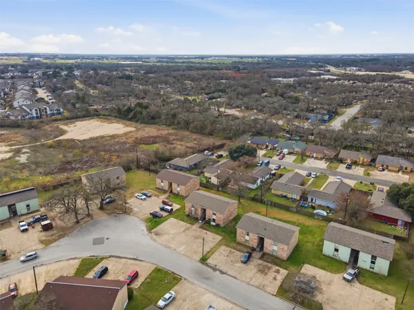 an aerial view of residential houses with outdoor space