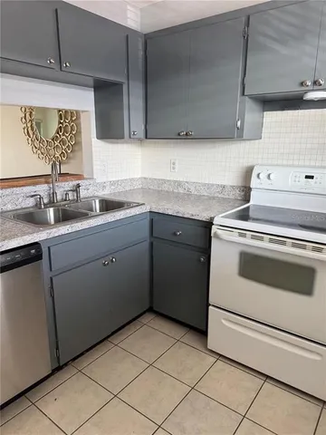 a kitchen with a stove sink and cabinets