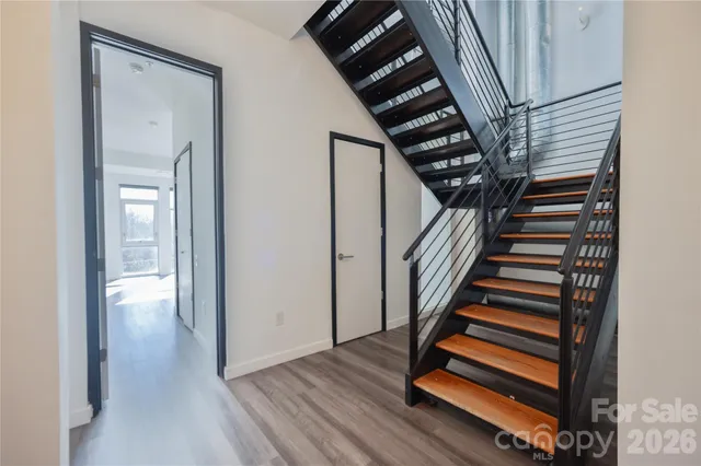 a view of entryway and hall with wooden floor